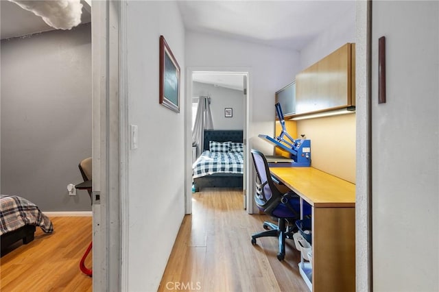 interior space featuring light hardwood / wood-style floors and vaulted ceiling