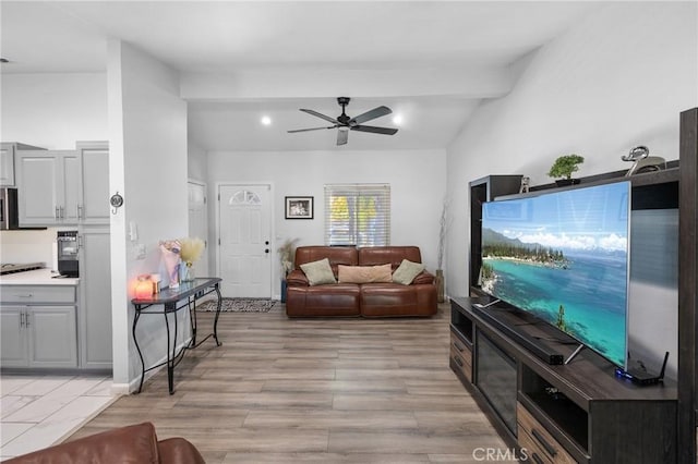 living room with ceiling fan, light hardwood / wood-style floors, and lofted ceiling with beams