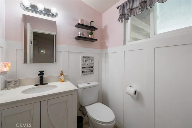 bathroom featuring vanity and toilet