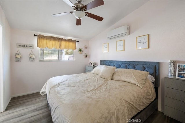 bedroom with hardwood / wood-style flooring, a wall mounted AC, lofted ceiling, and ceiling fan