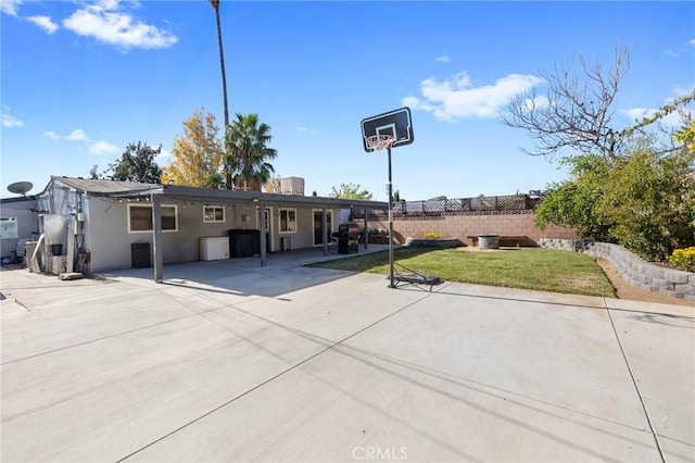 rear view of property featuring a lawn and a patio area