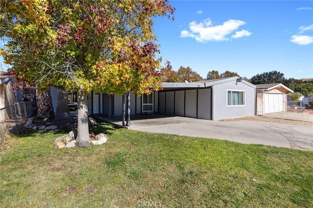 view of front facade with a front lawn and a carport