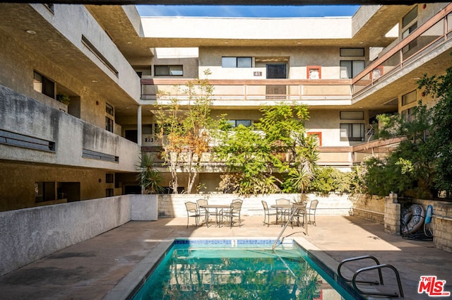 view of swimming pool with a patio