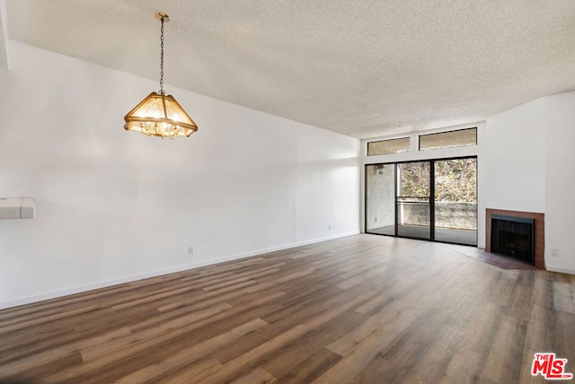 unfurnished living room featuring a textured ceiling and hardwood / wood-style flooring