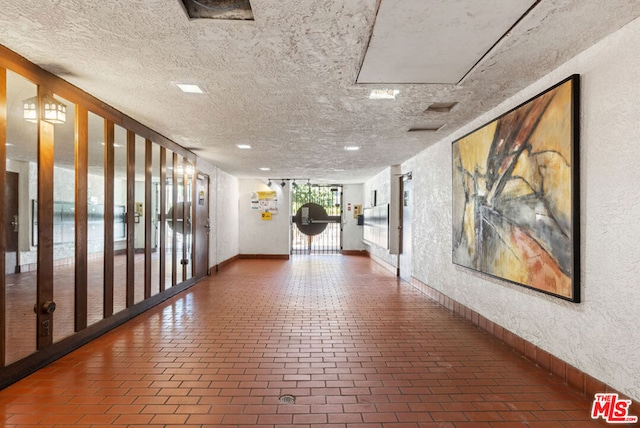 hallway featuring a textured ceiling