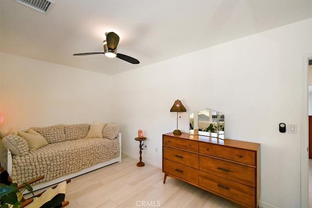 sitting room with light hardwood / wood-style flooring and ceiling fan