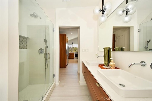 bathroom featuring vanity and a shower with shower door