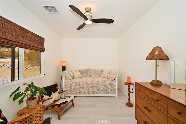 living area featuring ceiling fan and light wood-type flooring