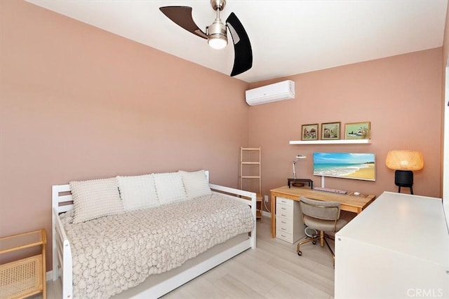 bedroom with light hardwood / wood-style floors, an AC wall unit, and ceiling fan