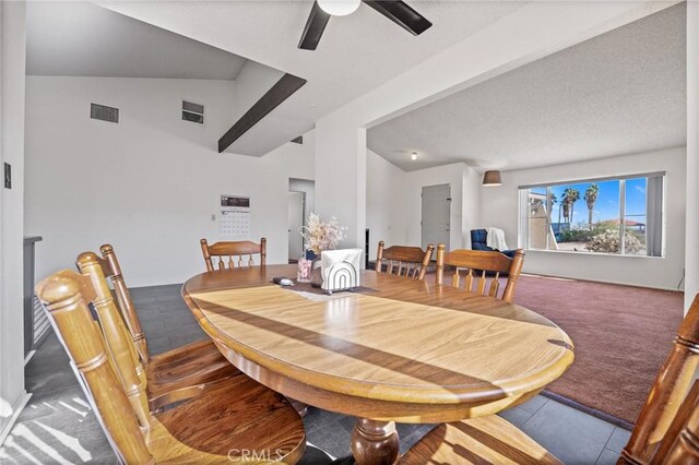 dining area with carpet, a textured ceiling, vaulted ceiling, and ceiling fan