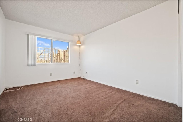 carpeted spare room featuring a textured ceiling