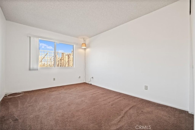 carpeted spare room with a textured ceiling