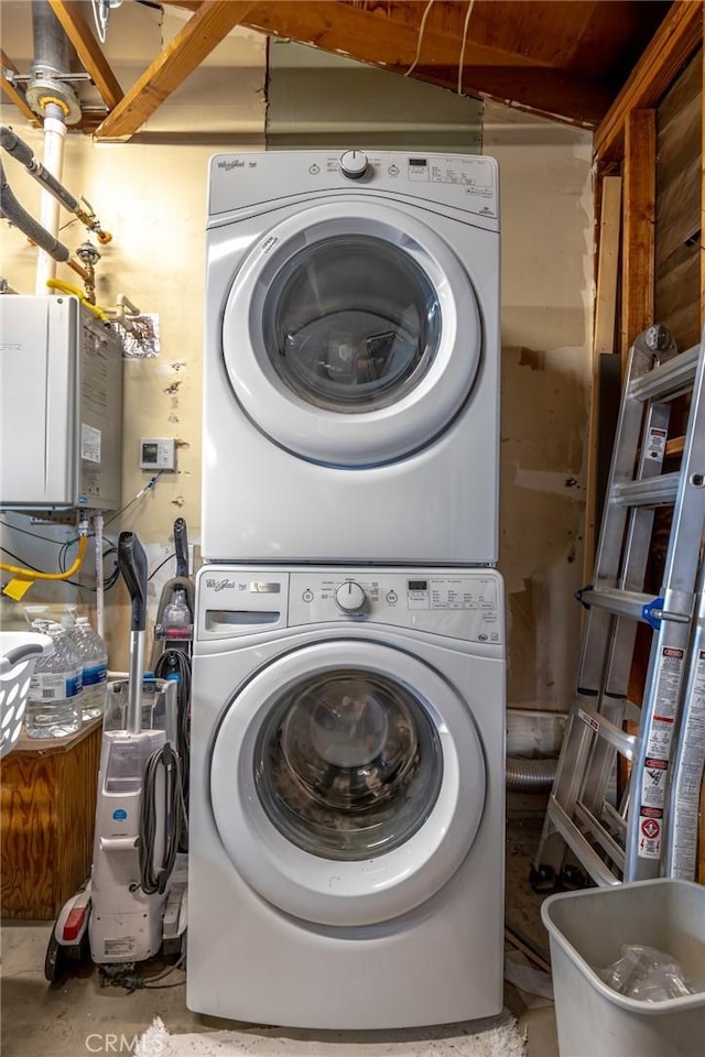 laundry room featuring stacked washer / drying machine