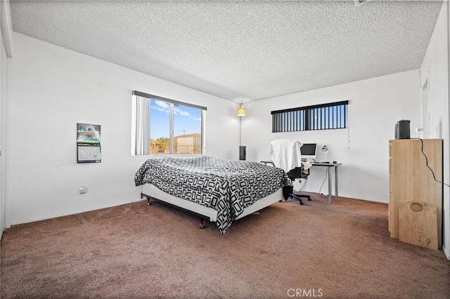 carpeted bedroom featuring a textured ceiling