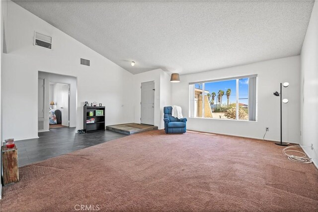 unfurnished living room with dark colored carpet, a textured ceiling, and high vaulted ceiling