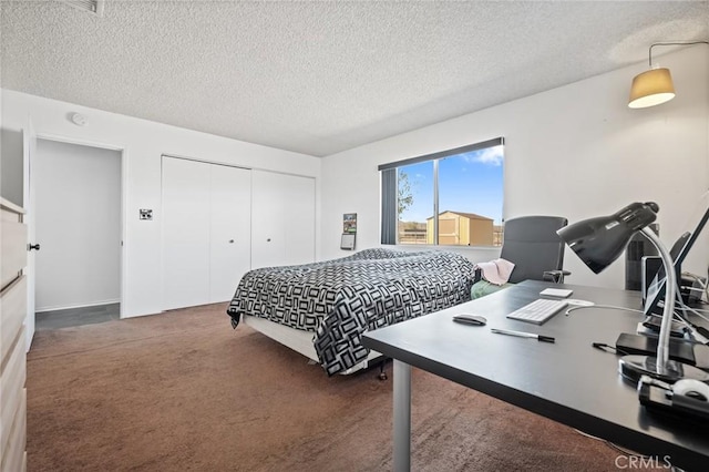 carpeted bedroom featuring a closet and a textured ceiling