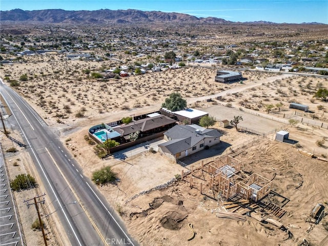 birds eye view of property featuring view of desert and a mountain view