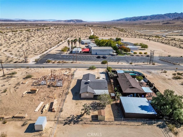 aerial view featuring a mountain view and view of desert