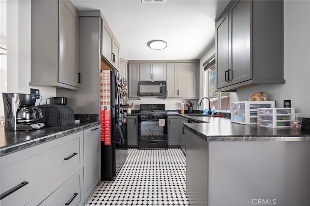 kitchen featuring gray cabinetry, sink, and black appliances