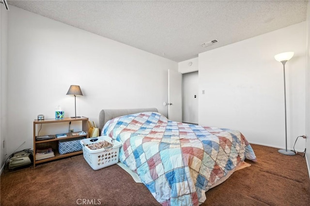 carpeted bedroom with a textured ceiling