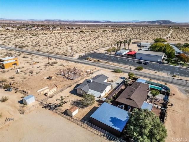 drone / aerial view featuring view of desert and a mountain view