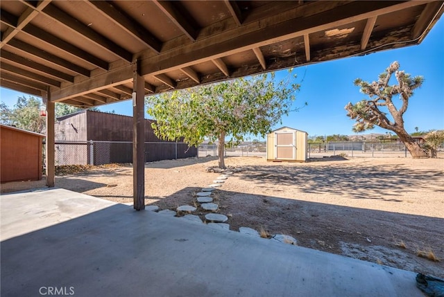 view of patio / terrace with a storage shed, a fenced backyard, and an outdoor structure