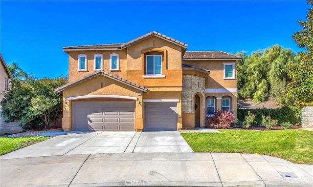 mediterranean / spanish-style house featuring a front lawn and a garage