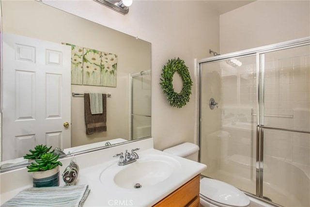 bathroom with vanity, toilet, and walk in shower