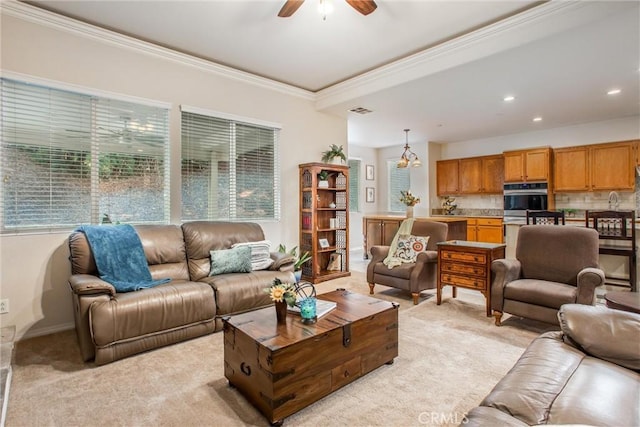 living room with light colored carpet, ceiling fan, and ornamental molding