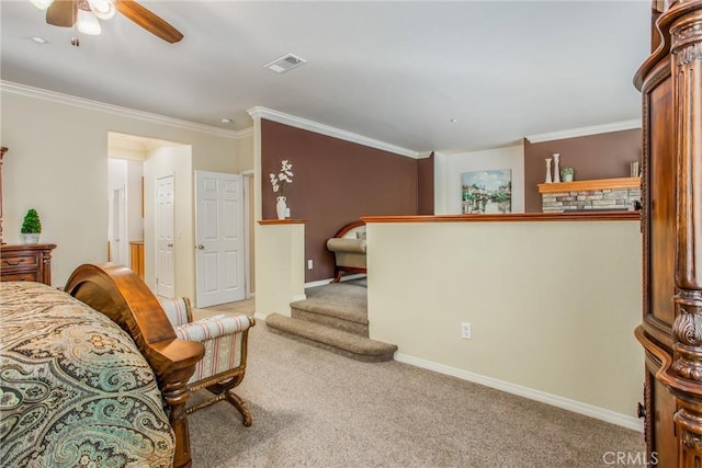 interior space with carpet flooring, ceiling fan, and ornamental molding