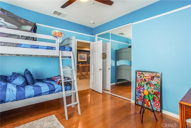 bedroom featuring ceiling fan, a closet, and wood-type flooring