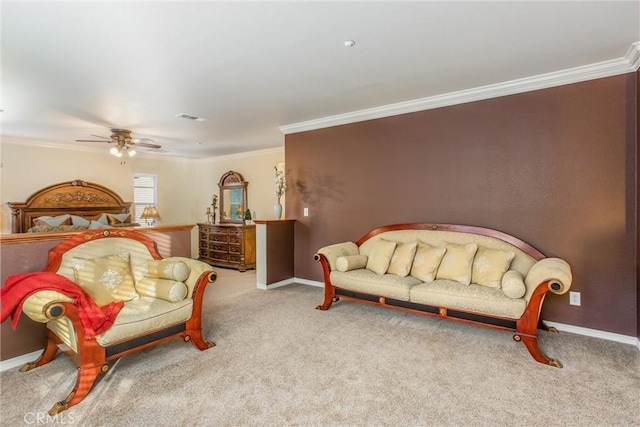 carpeted bedroom featuring ceiling fan and crown molding