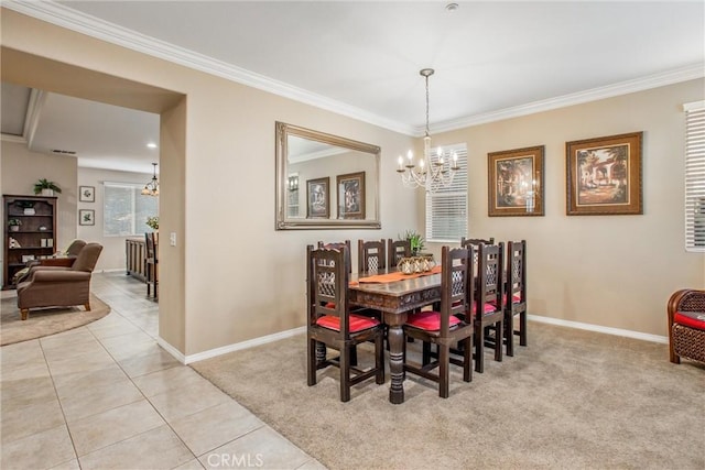 carpeted dining area with a notable chandelier and ornamental molding