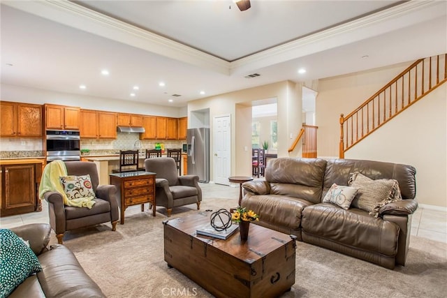 tiled living room with ceiling fan and ornamental molding