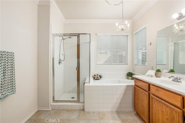 bathroom featuring vanity, tile patterned floors, crown molding, shower with separate bathtub, and a notable chandelier