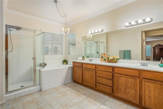 bathroom with tile patterned floors, ornamental molding, vanity, a notable chandelier, and shower with separate bathtub