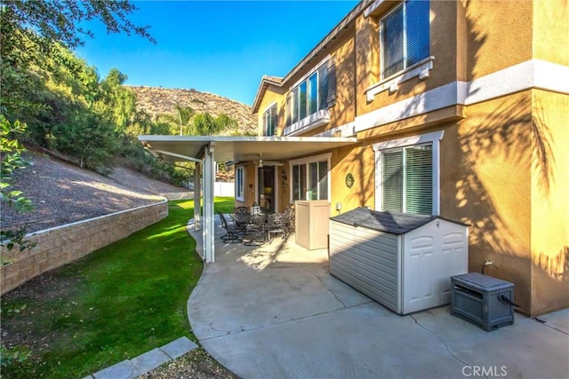 exterior space featuring a mountain view and a patio area