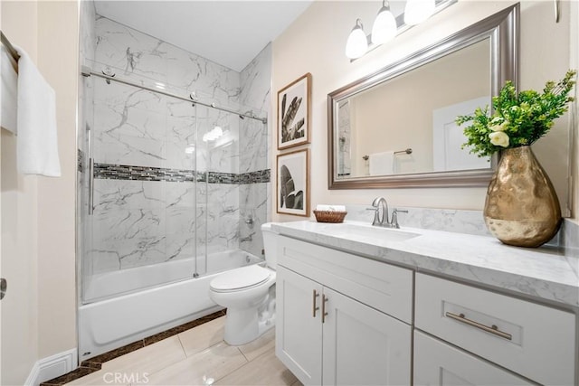 full bathroom featuring tile patterned floors, vanity, toilet, and bath / shower combo with glass door