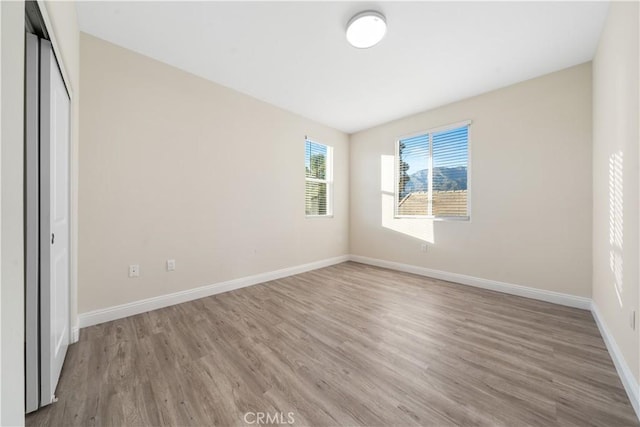 unfurnished bedroom featuring light wood-type flooring and a closet