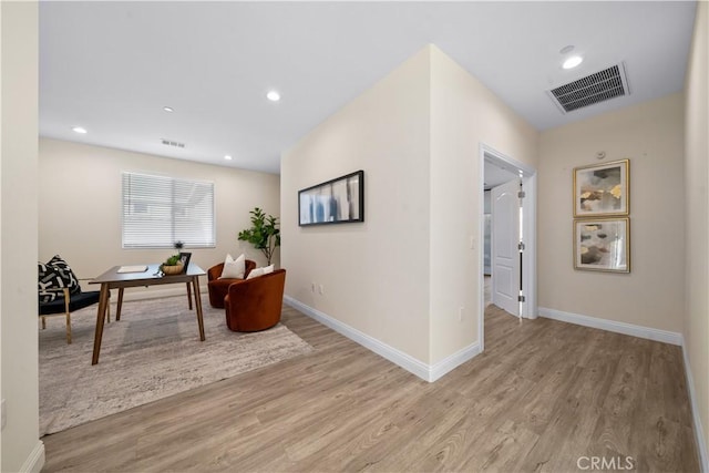 corridor with light hardwood / wood-style flooring