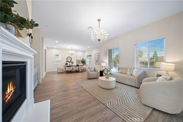 living room featuring hardwood / wood-style floors and an inviting chandelier