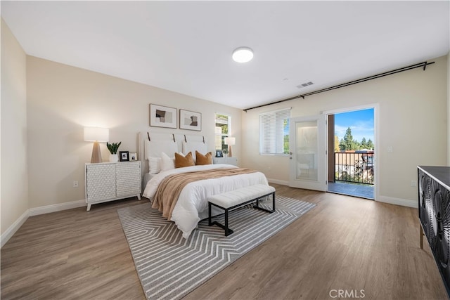 bedroom featuring hardwood / wood-style flooring, access to outside, and french doors