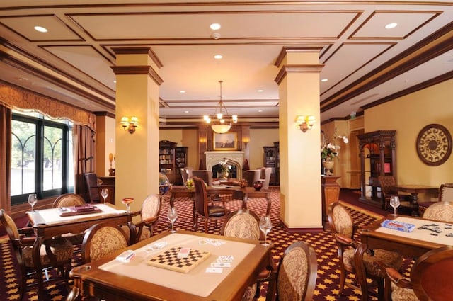 dining space featuring french doors, a notable chandelier, crown molding, and decorative columns