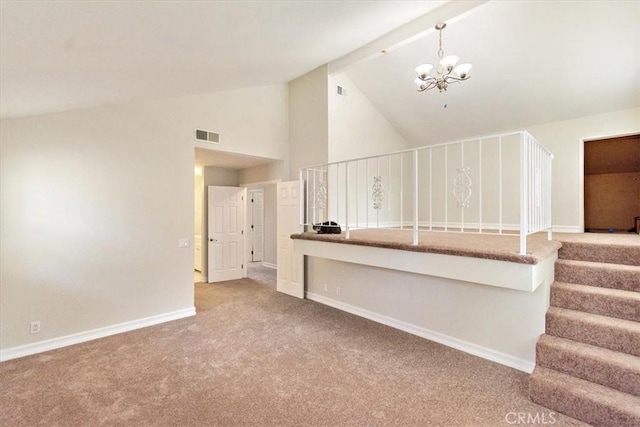 unfurnished living room featuring carpet flooring, a notable chandelier, and high vaulted ceiling