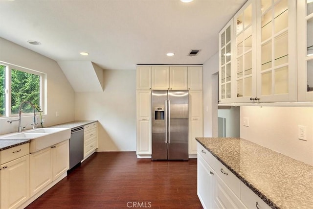 kitchen featuring white cabinetry, stainless steel appliances, and dark wood-type flooring