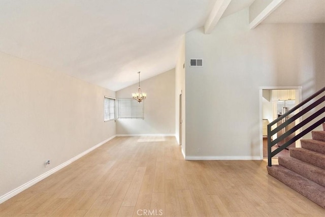 unfurnished living room featuring beamed ceiling, light wood-type flooring, high vaulted ceiling, and a chandelier