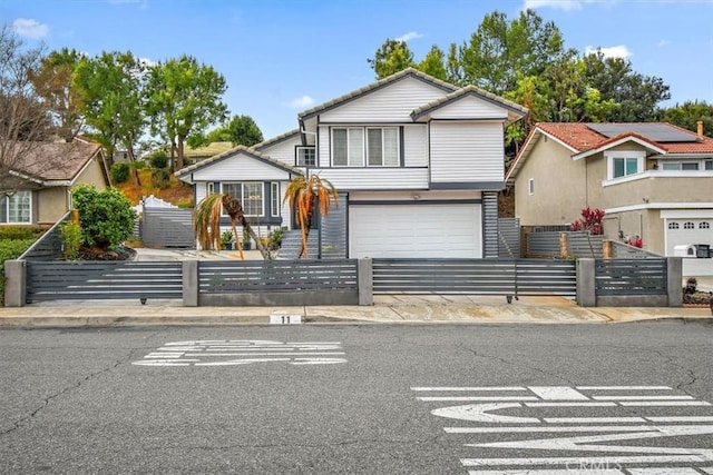 view of front of home featuring a fenced front yard and an attached garage