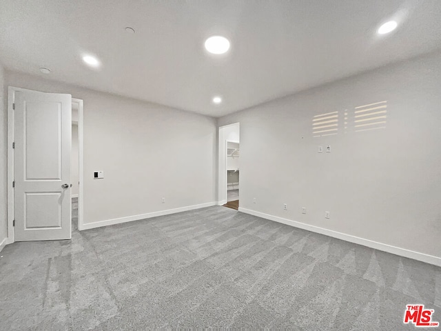 unfurnished room featuring carpet