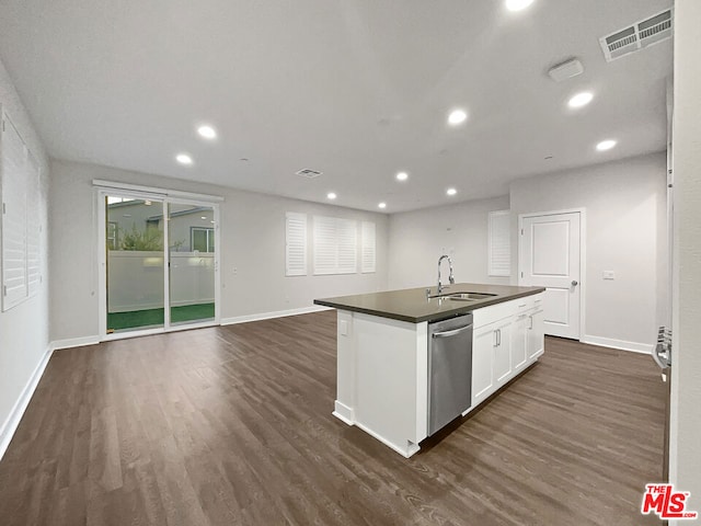 kitchen with stainless steel dishwasher, dark wood-type flooring, sink, a center island with sink, and white cabinetry