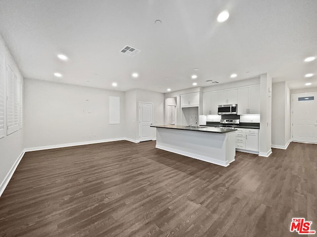 kitchen with a center island with sink, white cabinetry, dark wood-type flooring, and sink